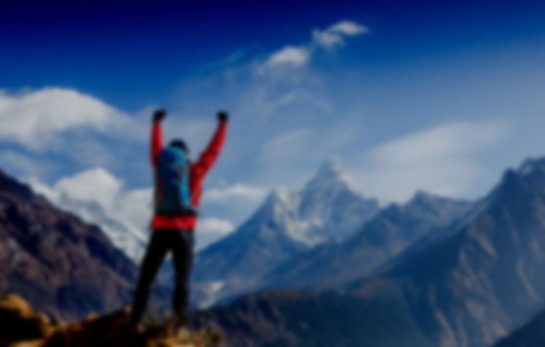Mountain climber celebrating reaching the summit